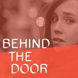 A person looking over their shoulder, with text overlaid that reads 'behind the door'
