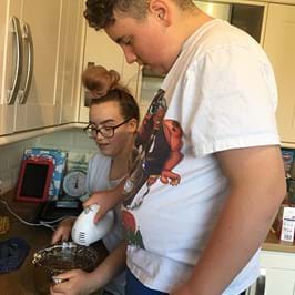 Two people baking a cake 