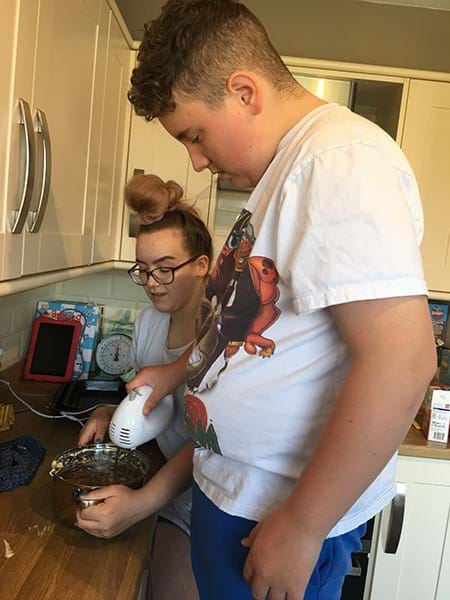 Two people baking a cake 