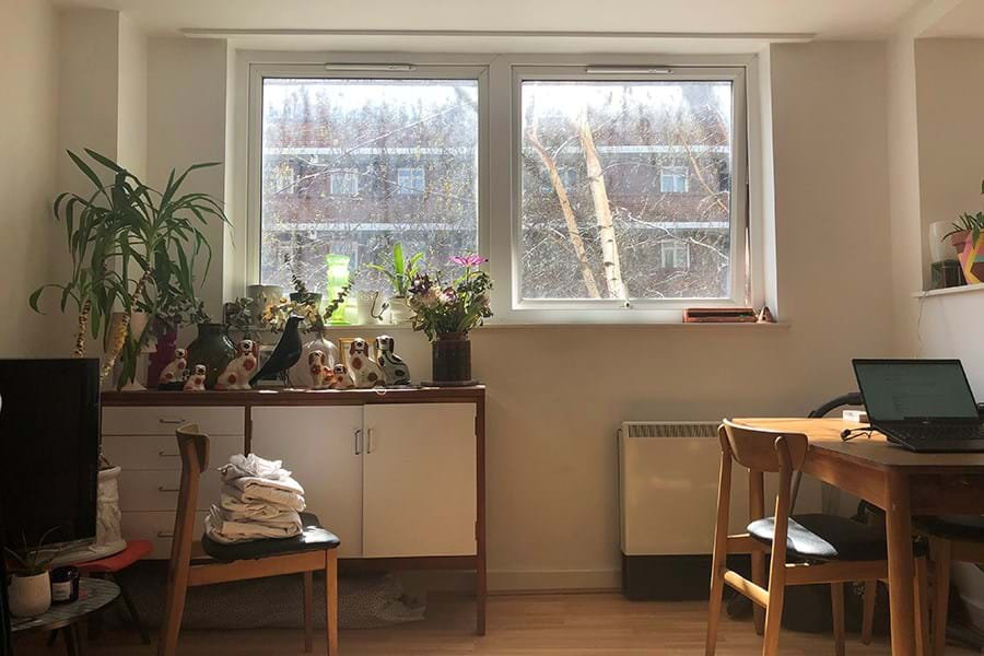 Kitchen table and sideboard, with view of silver birches through closed windows