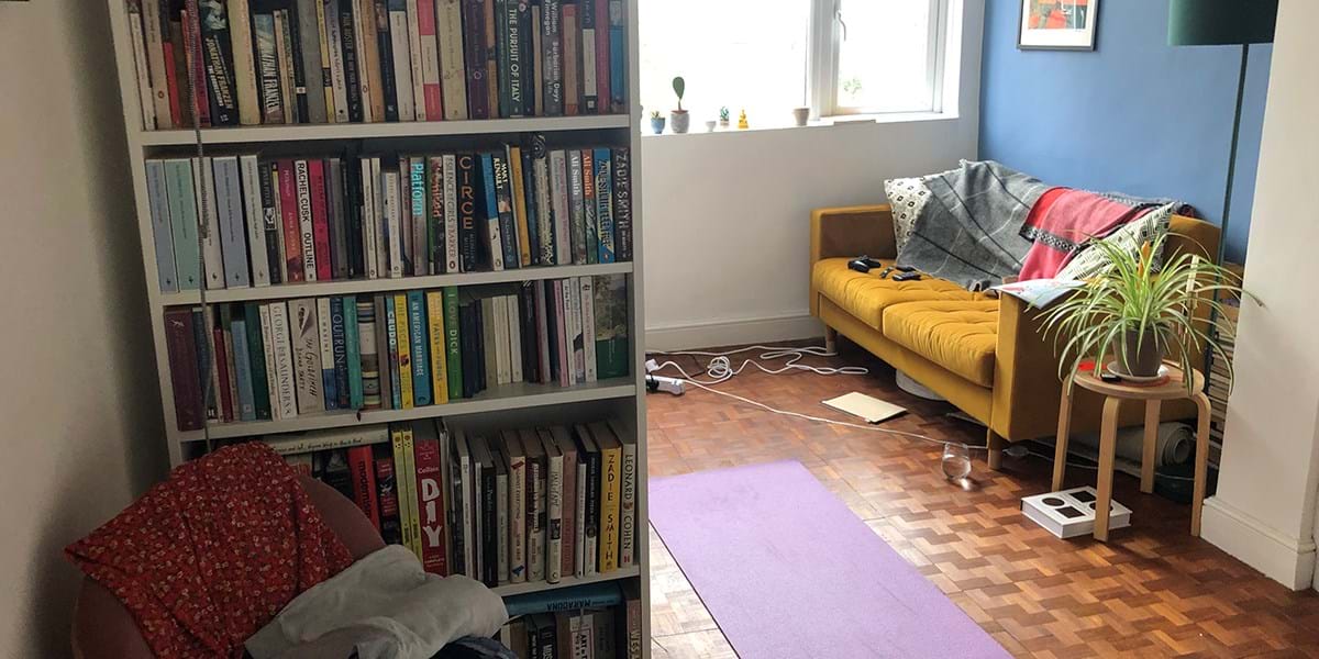 Purple yoga mat, with bookshelves and yellow sofa