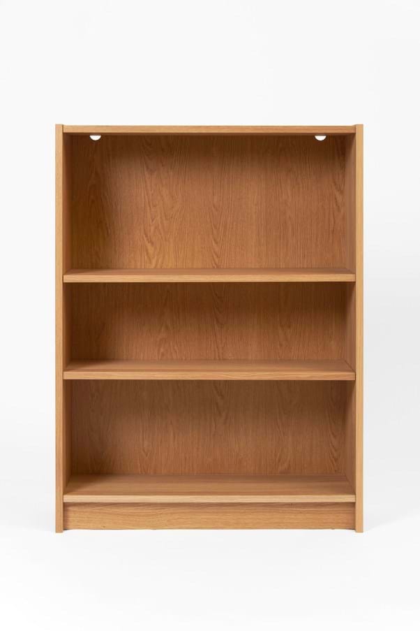 A light brown wooden bookshelf unit